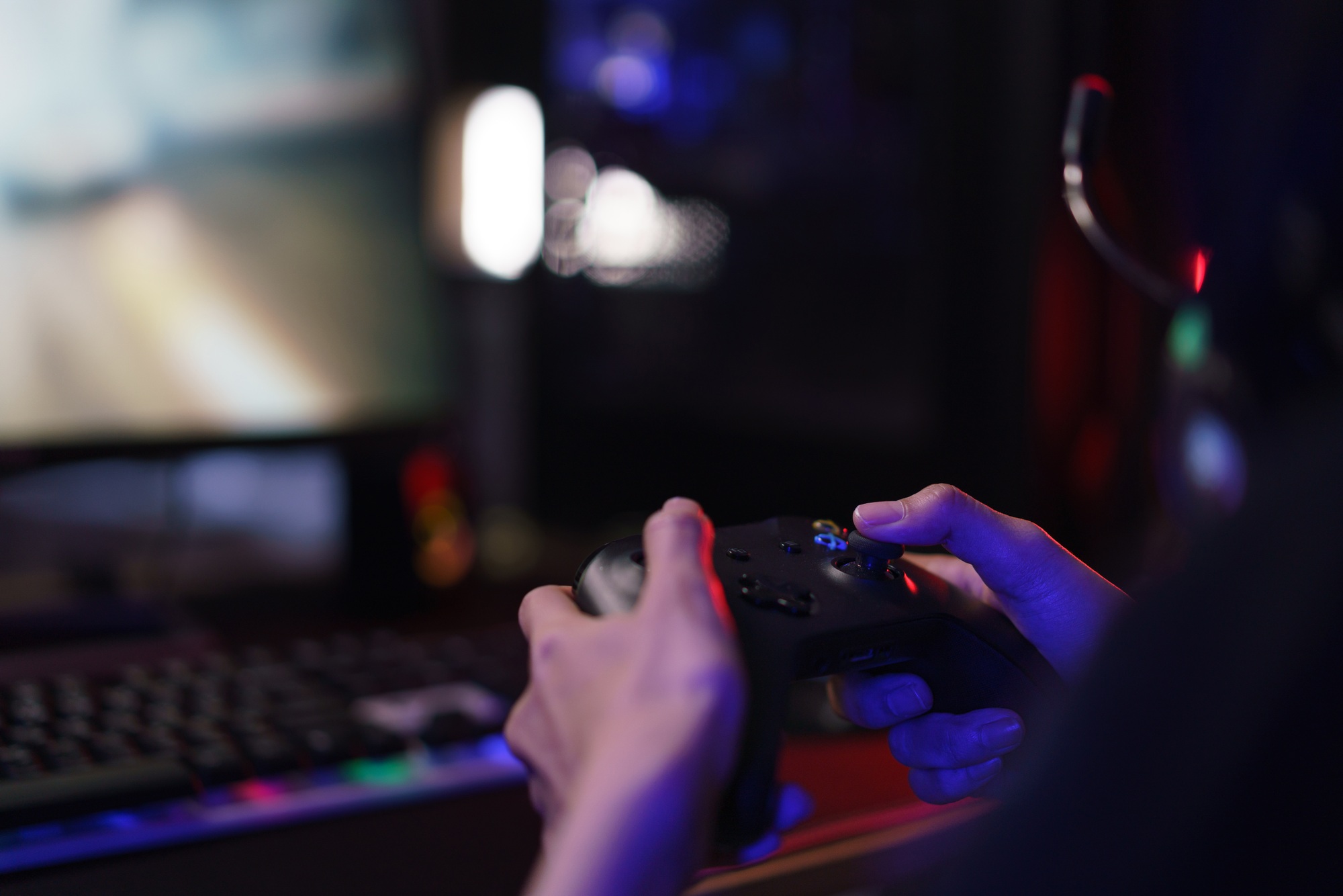 Hand of female cyber hacker gamer holding controller joystick to playing games on computer